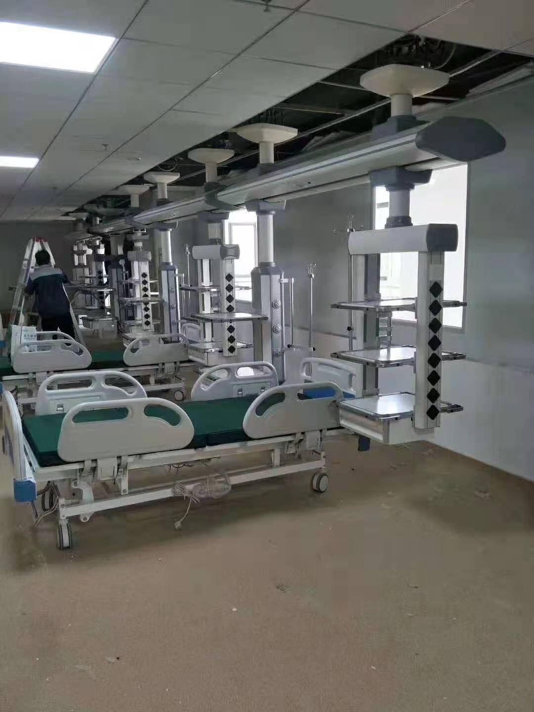 Modern hospital procedure room with adjustable patient bed illustrating clearances needed around a central operating table