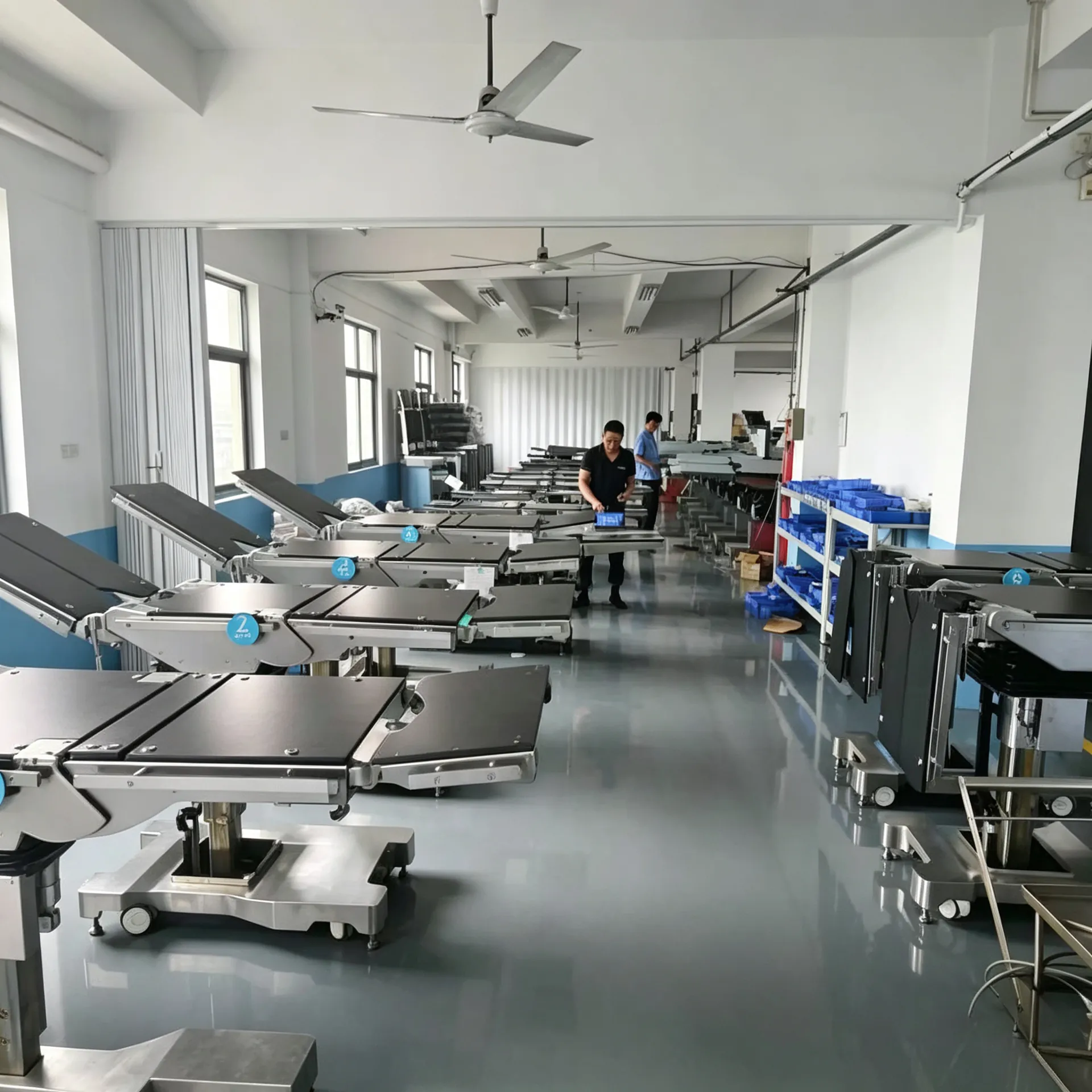 Rows of finished operating tables staged in the factory for pre-shipment testing