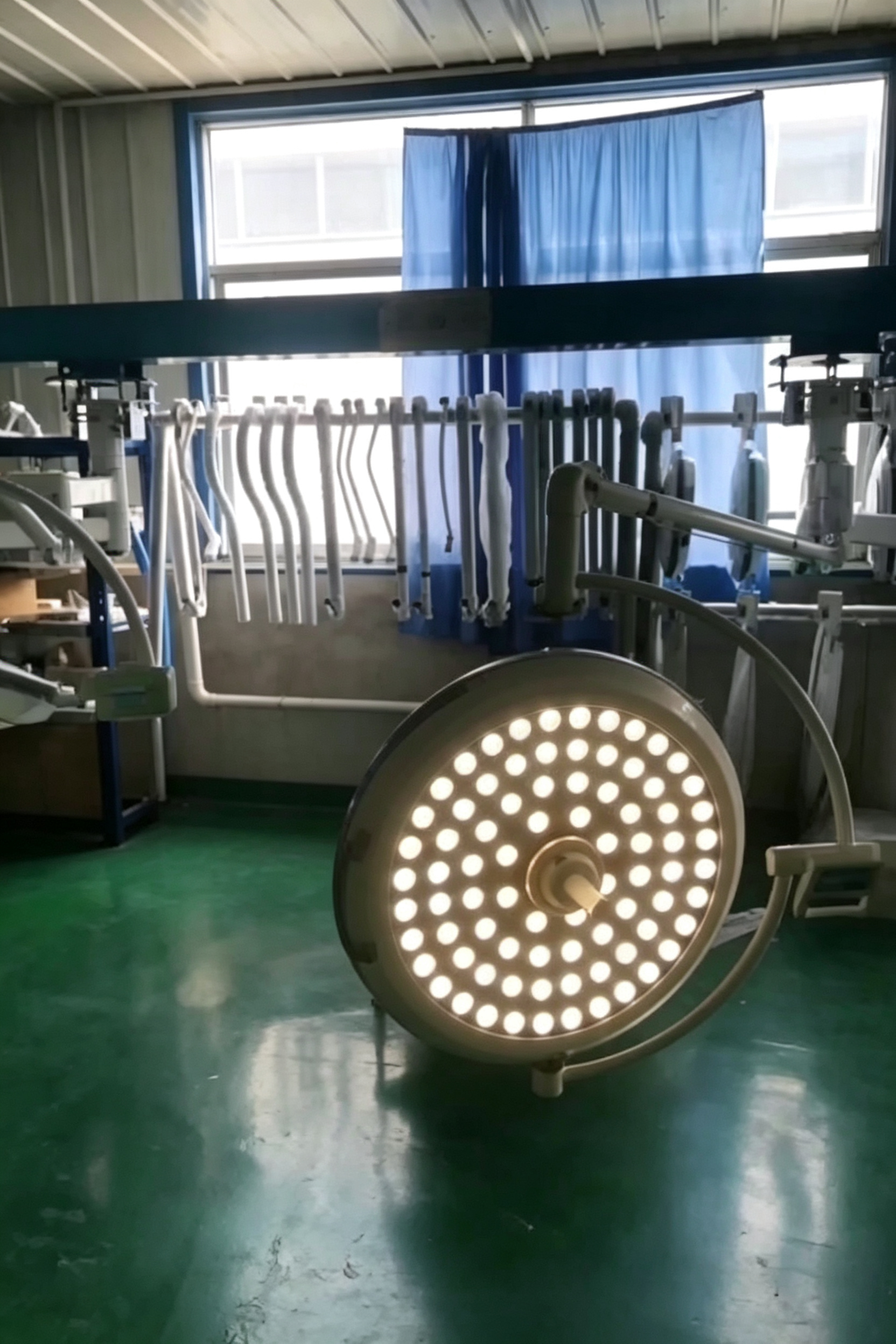 Rows of completed surgical light systems awaiting final inspection and packing