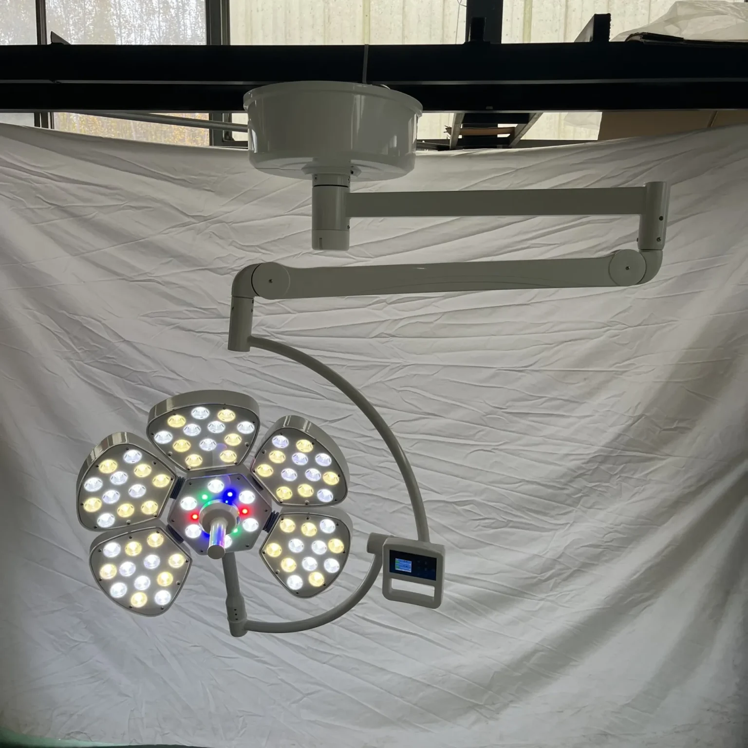 Close-up of Petal Five surgical light with integrated HD camera module in the central aperture