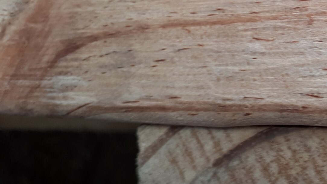 Solid wood deck boards of an export pallet, the footprint whose corner-to-corner diagonal decides whether a packed medical unit passes a hospital lift door
